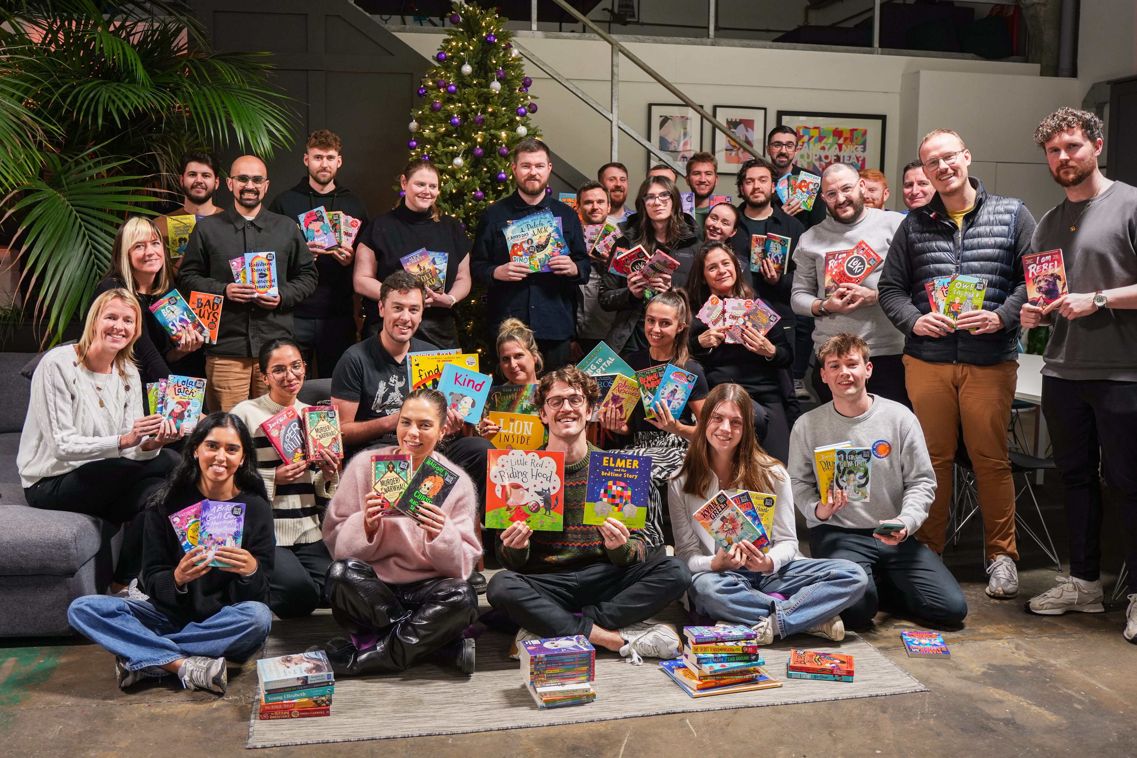 The Agent Team holding books up